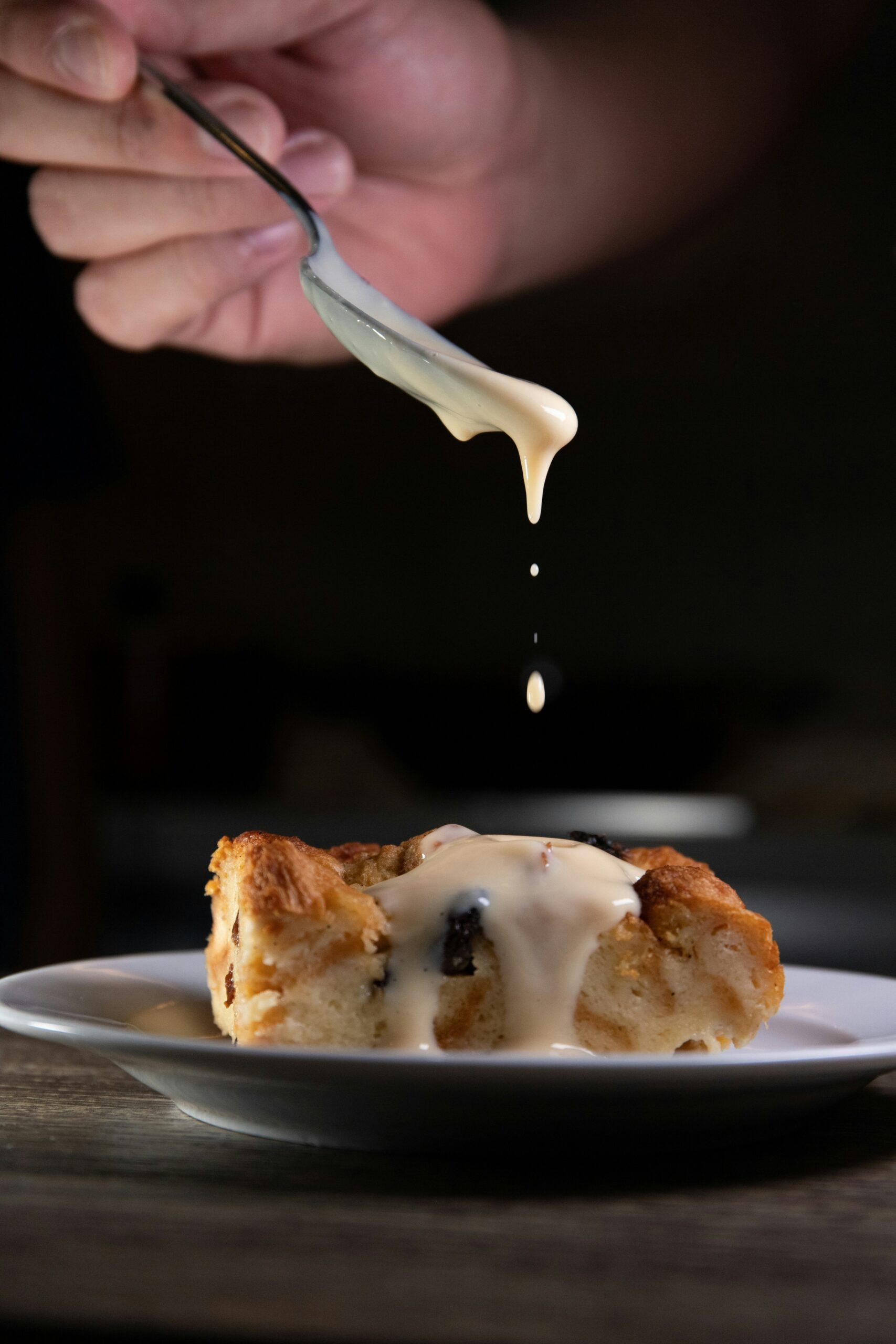 person holding stainless steel fork with white cream